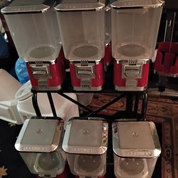 set of 6 red and chrome square-head bulk vending machines, likely Rhino Vending machines.