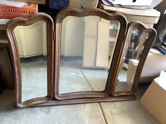 Vintage French Provincial trifold dresser mirror with scalloped crest molding and adjustable hinged side panels.