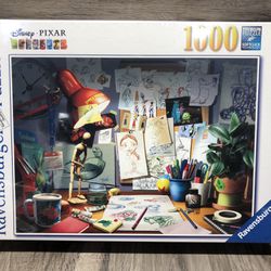 Disneys Pixar Ravensburger 1000 Piece Puzzle “The Artist’s Desk” 20”x27” Sealed