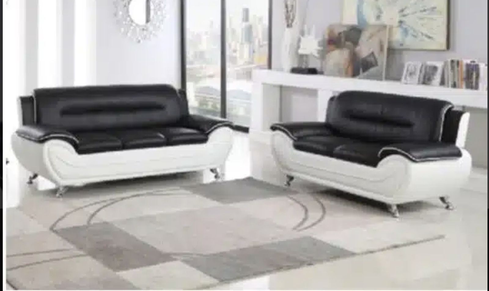 The set is designed with a modern minimalist style and is upholstered in top-grade bonded leather for a smooth, easy-to-clean surface. The set also fe