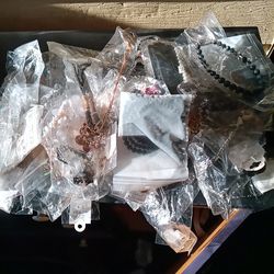 Grocery bag full of costume jewelry necklaces