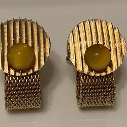 Vintage wrap around cufflinks gold tone with a round stone. Color of stone is butterscotch. Preowned.