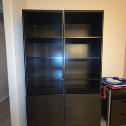 2 tall black display cabinets