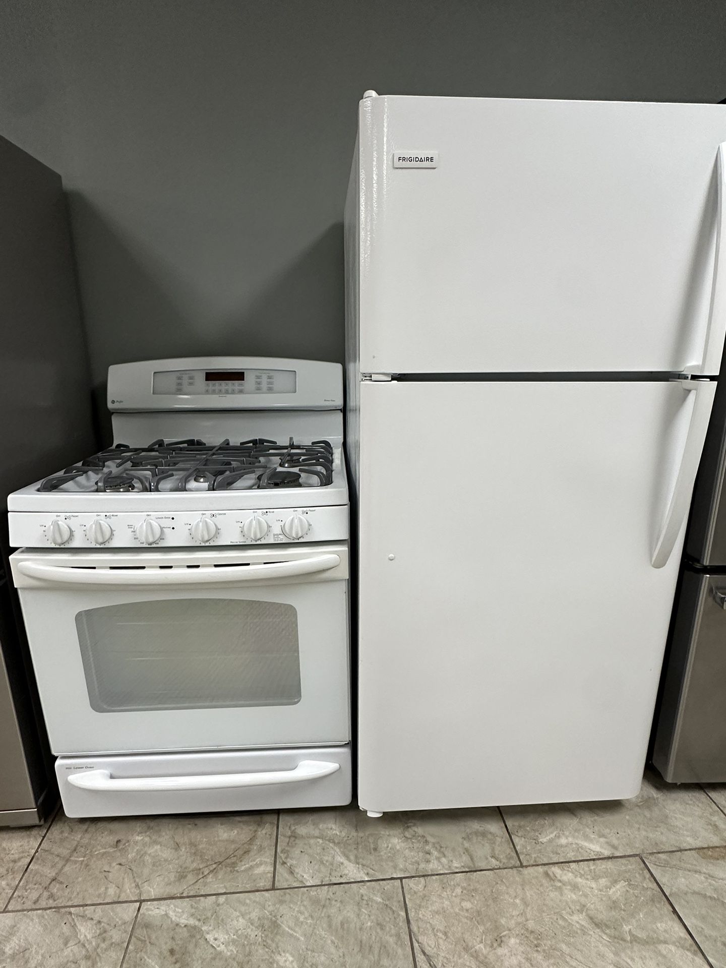 Frigidaire top freezer refrigerator and GE double oven gas range set