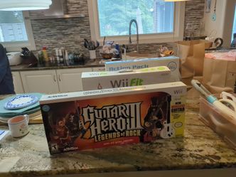Wii , guitar hero guitar, Wii fit balance board, and Wii action pack