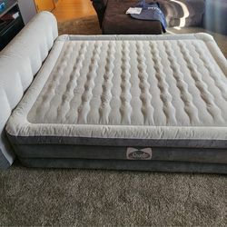  Sealy Tritech Queen-sized air mattress with a headboard. 