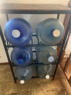5 gallon jug holder with 6 jugs one has a spout