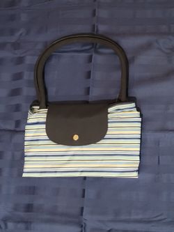 Nivea Folding Travelling Beach Bag featuring a blue, yellow, and white striped pattern.