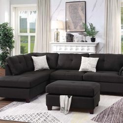 ASH BLACK SECTIONAL WORH REVERSIBLE CHAISE. OTTOMAN INCLUDED 