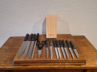 Amazon Basics 14-Piece High Carbon Stainless Steel Kitchen Knife Set with black triple-riveted handles and a pine wood block.