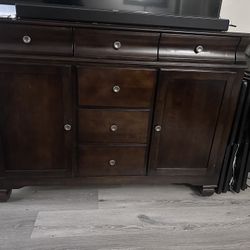 rich walnut-finished or server cabinet that can be used as a buffet or an entertainment center