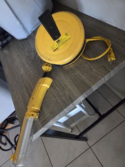 LumaPro retractable extension cord reel with an integrated work light