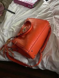 Orange purse with wallet and additional bag