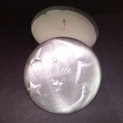 NEW CANDLE IN SHINY TIN CONTAINER, COVER HAS HALF MOON AND STARS CARVED ON IT