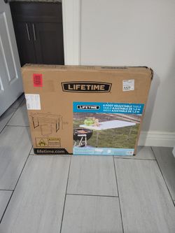 Brand new 4ft adjustable table in box. PRICE IS FIRM