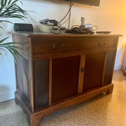 Record cabinet.  Uncertain if record player or stereo works it’s currently being used as a vintage video game system cabinets but be awesome to use as