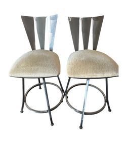 Modern bar stools with a circular metal base.
