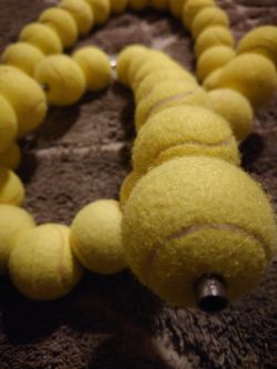 42 Tennis balls with holes in them ex Lacoste display great decor ideas or for pets