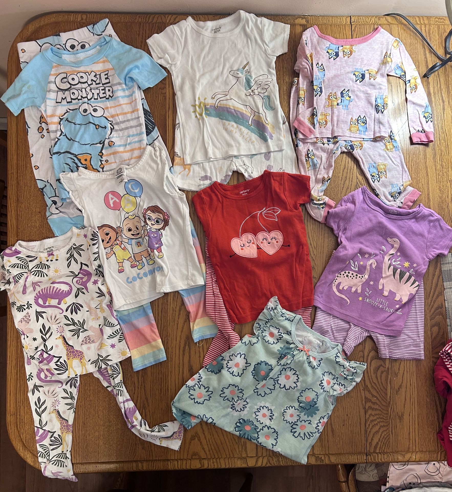 Lot of 8 - Girls 2T PJ’s Carters, cocomelon, Bluey Sesame Street