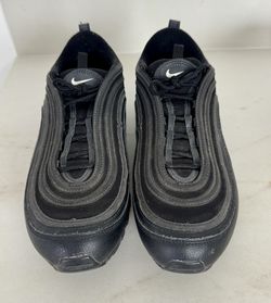 A pair of Nike Air Max 97 sneakers in an all-black colorway