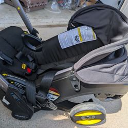 Doona car seat and stroller with base and protective seat cover