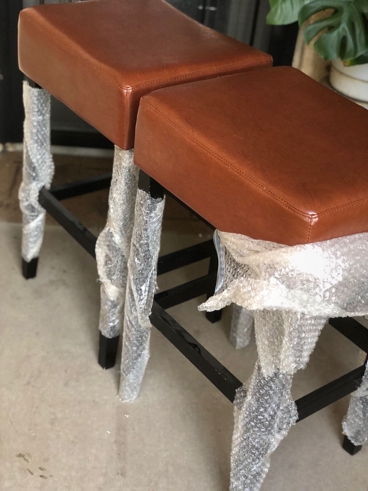 Brand new set of leather saddle back barstools. Retails for $420