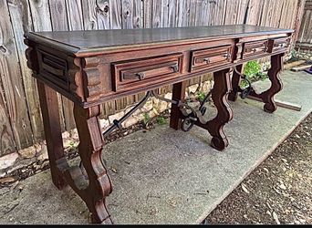 Gorgeous Jason Scott Spanish Prison console table features a dark wood finish and decorative iron
