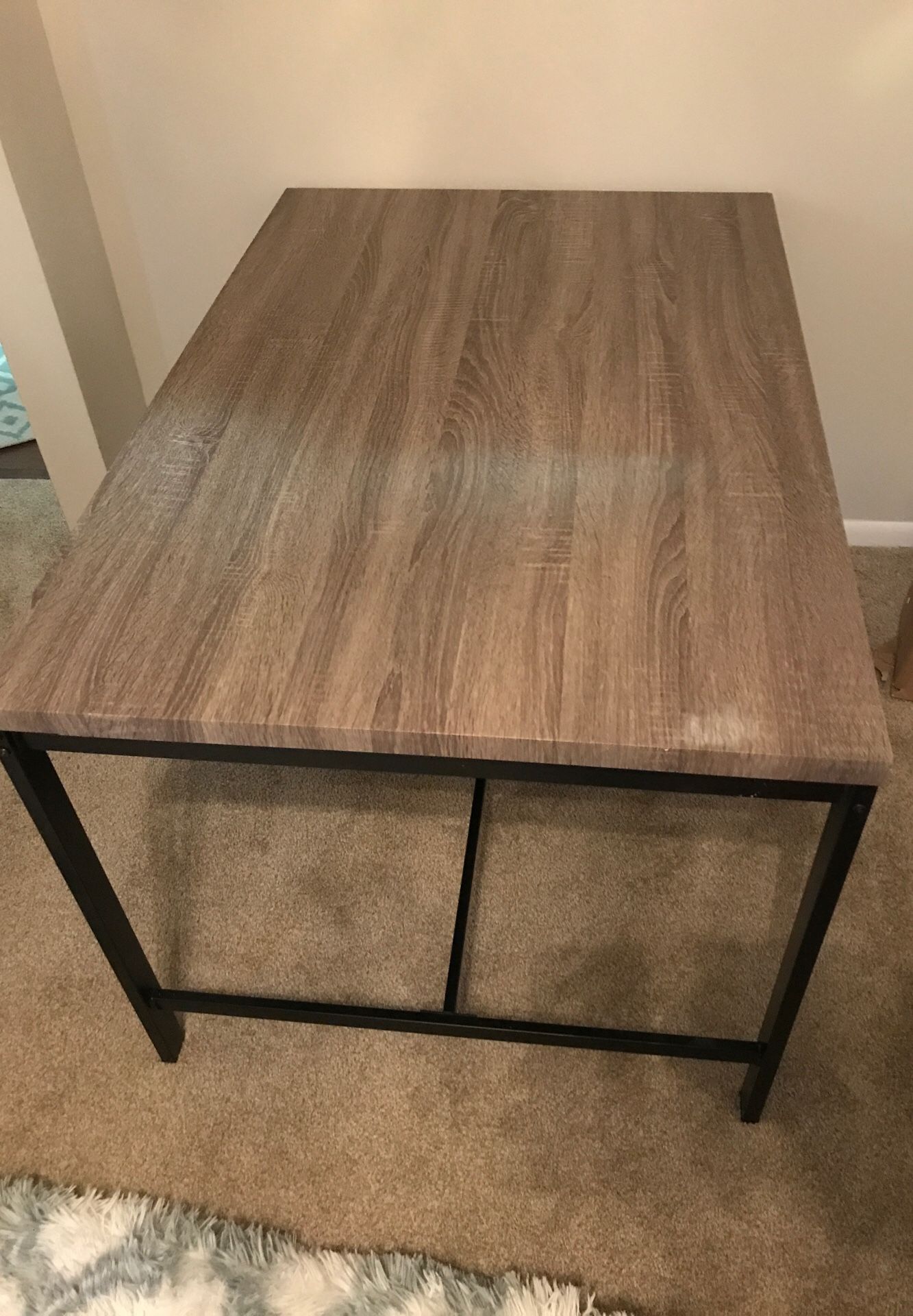 Faux wood dining table with two bench chairs