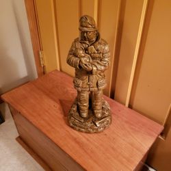 Firefighter With Baby Statue.