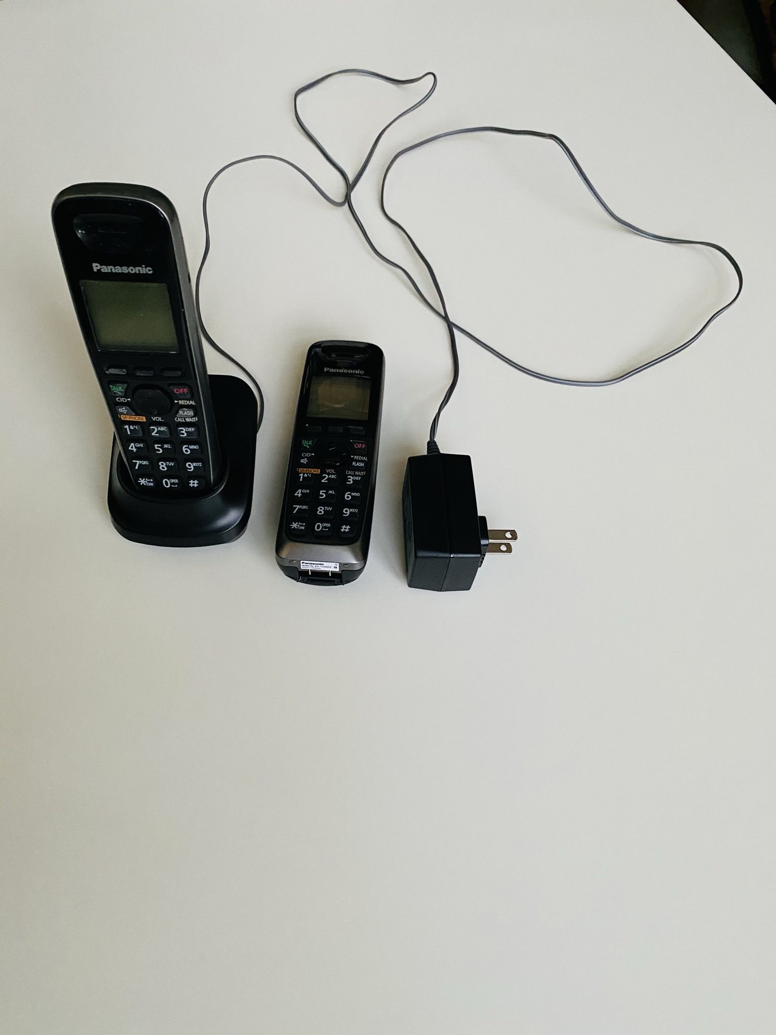 2 Panasonic KX-TGA653 Wireless Telephone Handsets; Panasonic PNLC1010 YA Cordless Phone Expansion Handset Charger Cradle; and Panasonic PQLV219 AC Ada