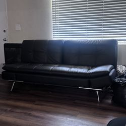 Two leather couches with USB and plug inputs