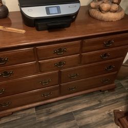 Vintage cherry wood dresser with brass handles, tallboy, headboard, and long wooden dresser