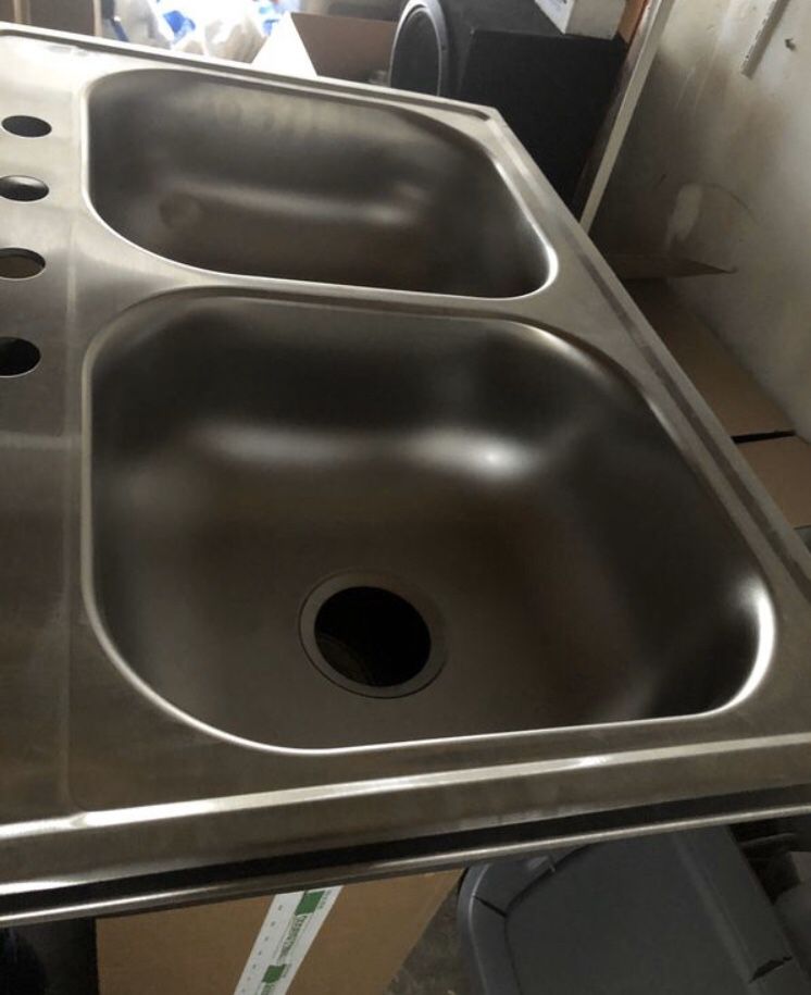 double bowl kitchen sink stainless steel. 22 by 33. Bowls 7” deep I think