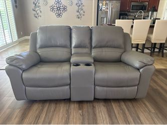 Leather love seat sofa w/double recliner and charging port .