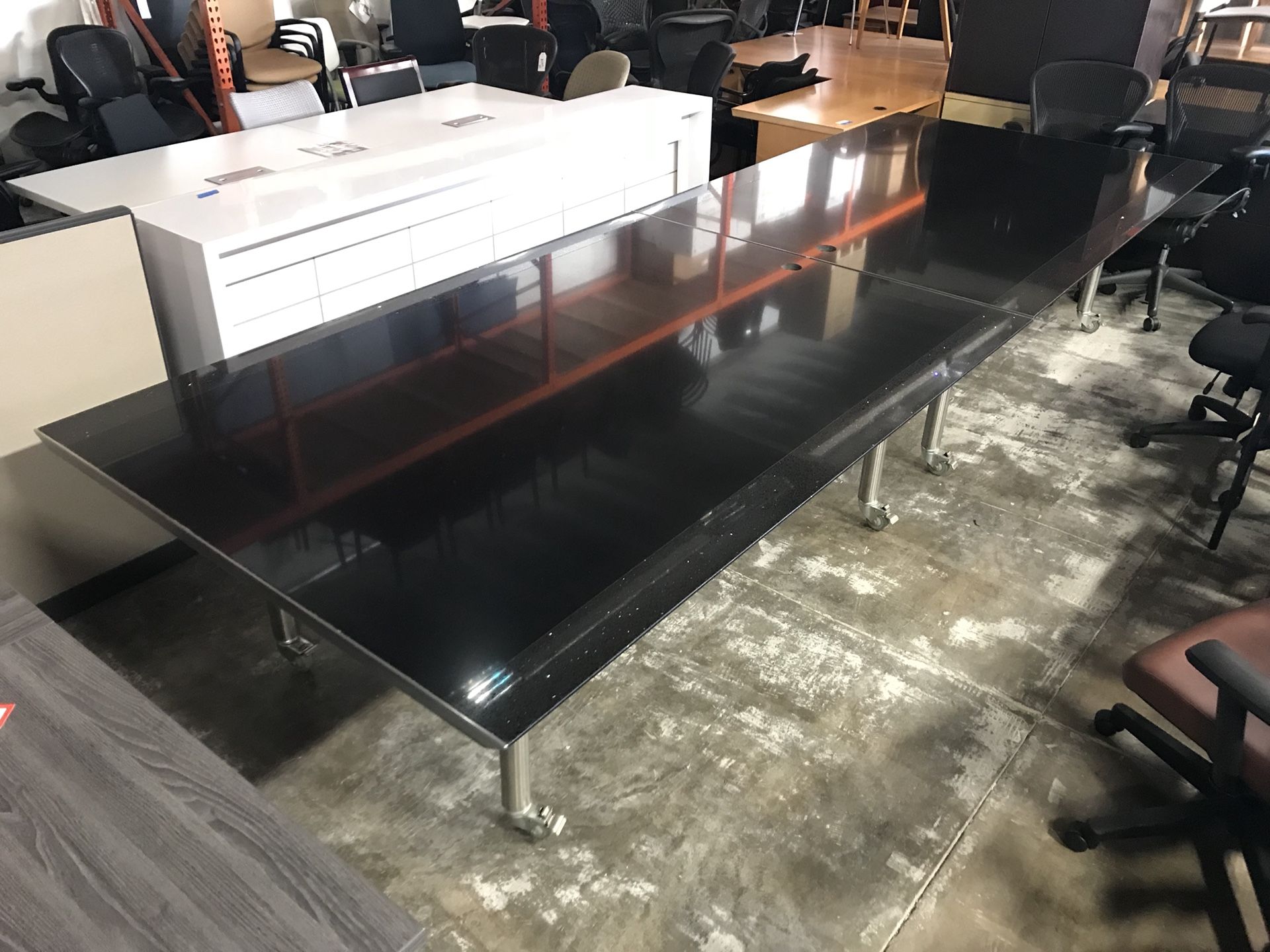 14’ ft conference table in all black Quartz material with rolling base