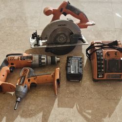 Ridgid 18V cordless power tool set, likely including a circular saw, drill/driver, and impact driver/Charger 
