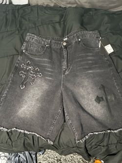 Black baggy jean shorts with cross symbols