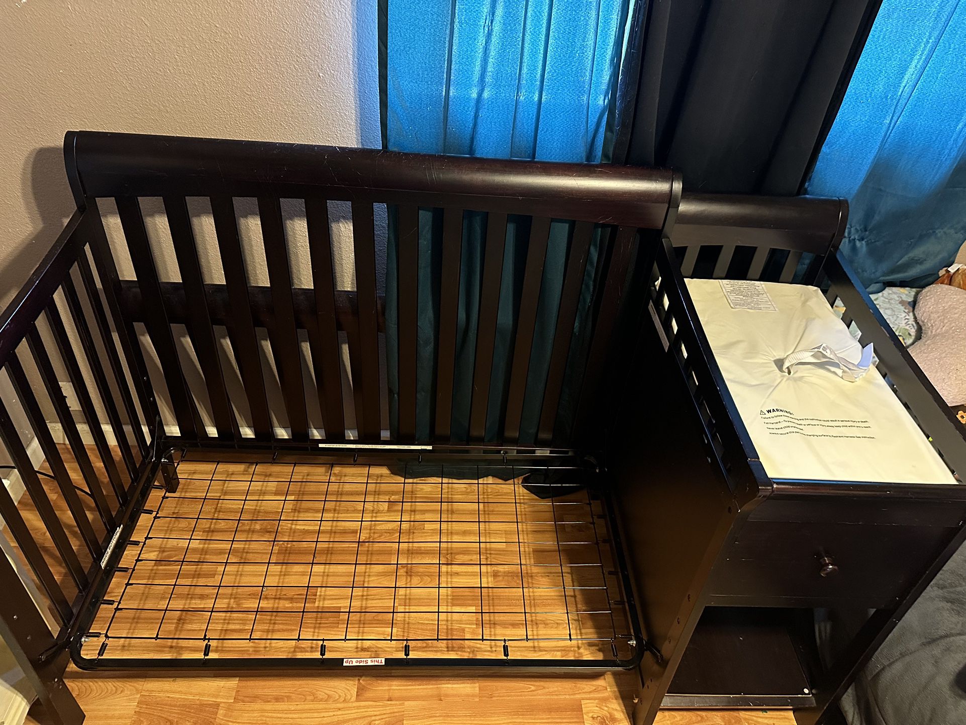 Crib with connected changing table.