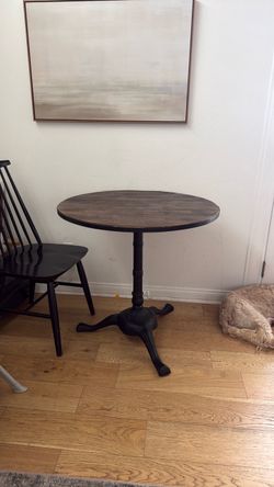 Wooden pedestal table with metal legs