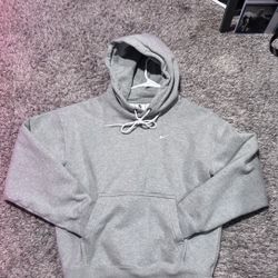 Thick material nike grey hoodie with white strings.