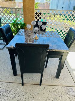 Dining table with 4 leather chairs.