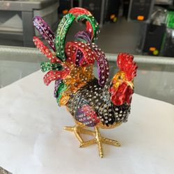 Everly Quinn This beautiful colorful rooster statue embedded with a lot of shining crystals is one of the powerful feng shui products to ward off argu