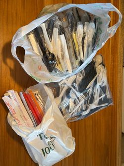 Plastic utensils, wooden chopsticks and plastic straws