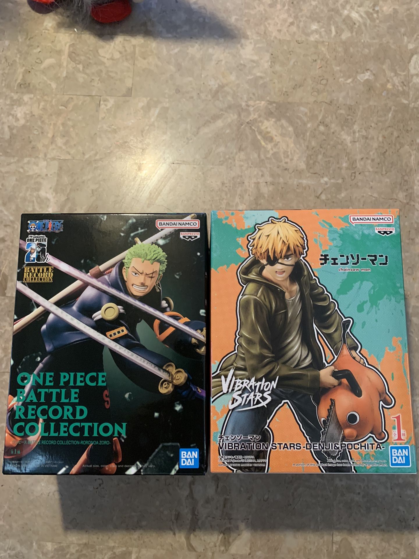 Zoro and Denji statues