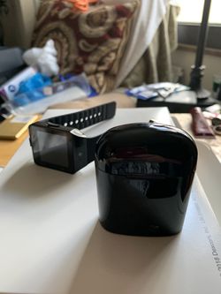 Black smart watch and black Bluetooth headset combination