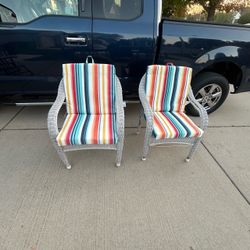 Nice pair of white wicker patio armchairs with multi-colored vertical stripe cushions chairs stack