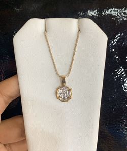 Beautiful coin pendant in gold bezel with silver chain