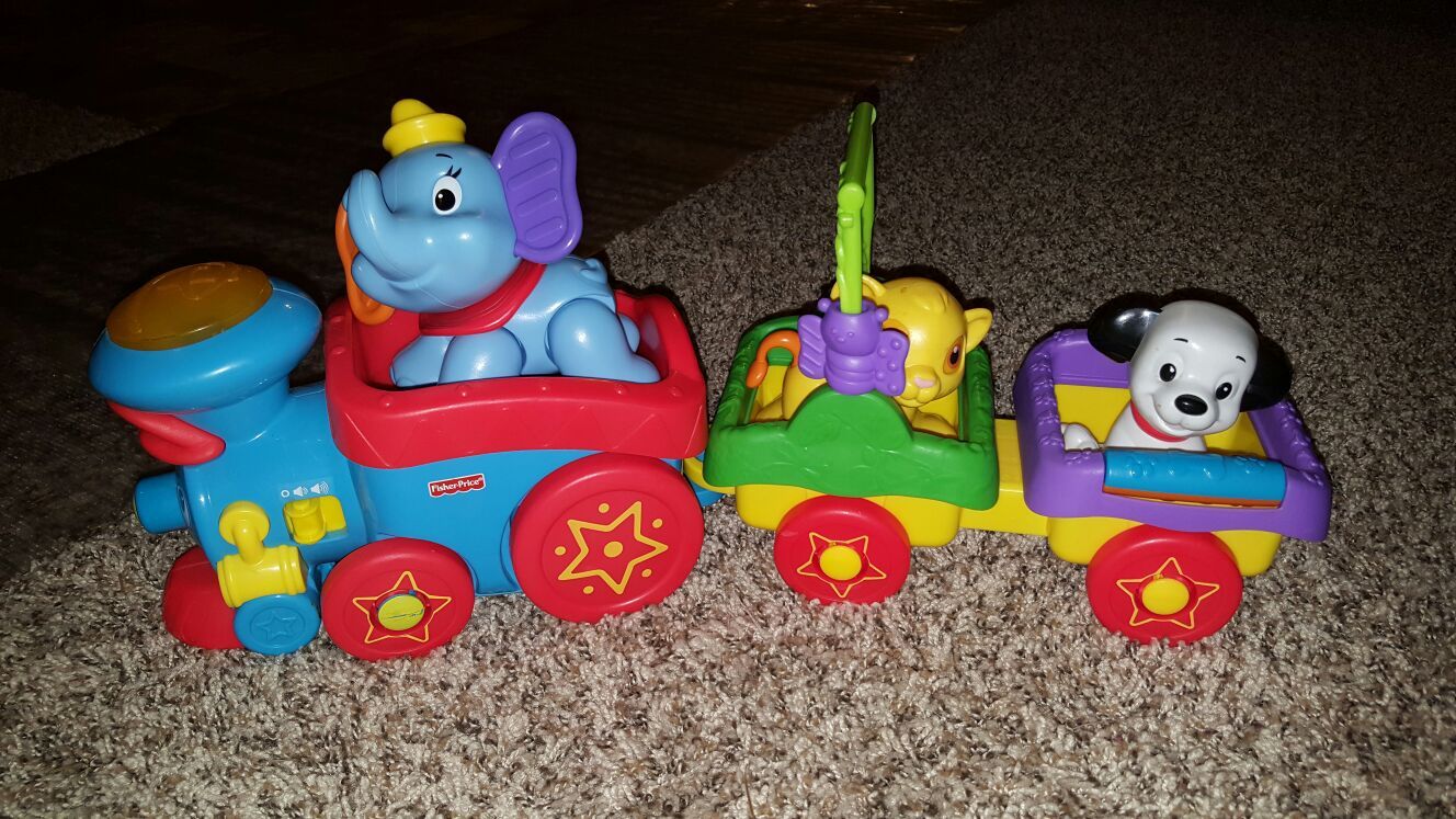 Fisher price disney toy train with dumbo, lion king simba, and dalmatian from 101 Dalmatians