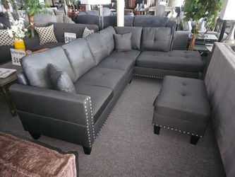 Brand new 99" x 66" dark gray sectional with cup holders and storage ottoman