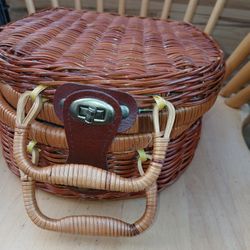 handwoven wicker picnic basket with a hinged lid and an internal fabric liner featuring a green and purple olive branch pattern